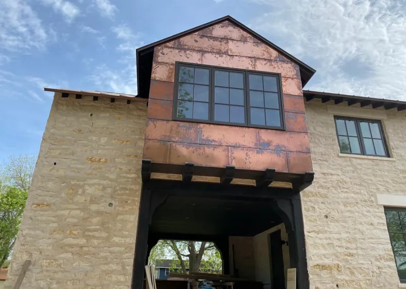 Copper metal panel facade on a stone building for Skylight Installation in Upland