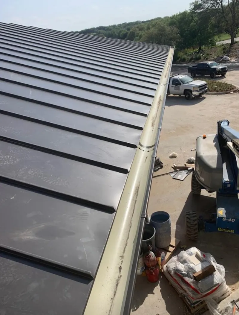 Standing seam panel and gutter detail on a metal roofing jobsite in Upland